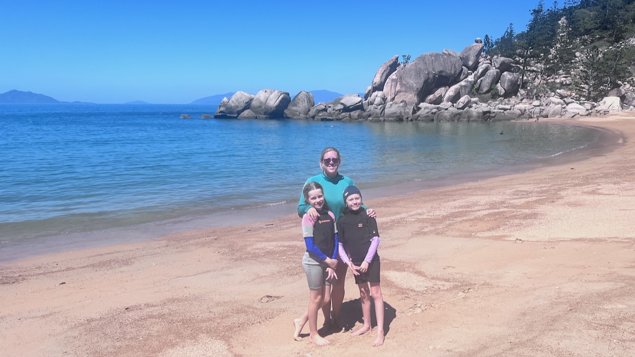 My girls. The rock we climbed is the one at the end of the beach behind them