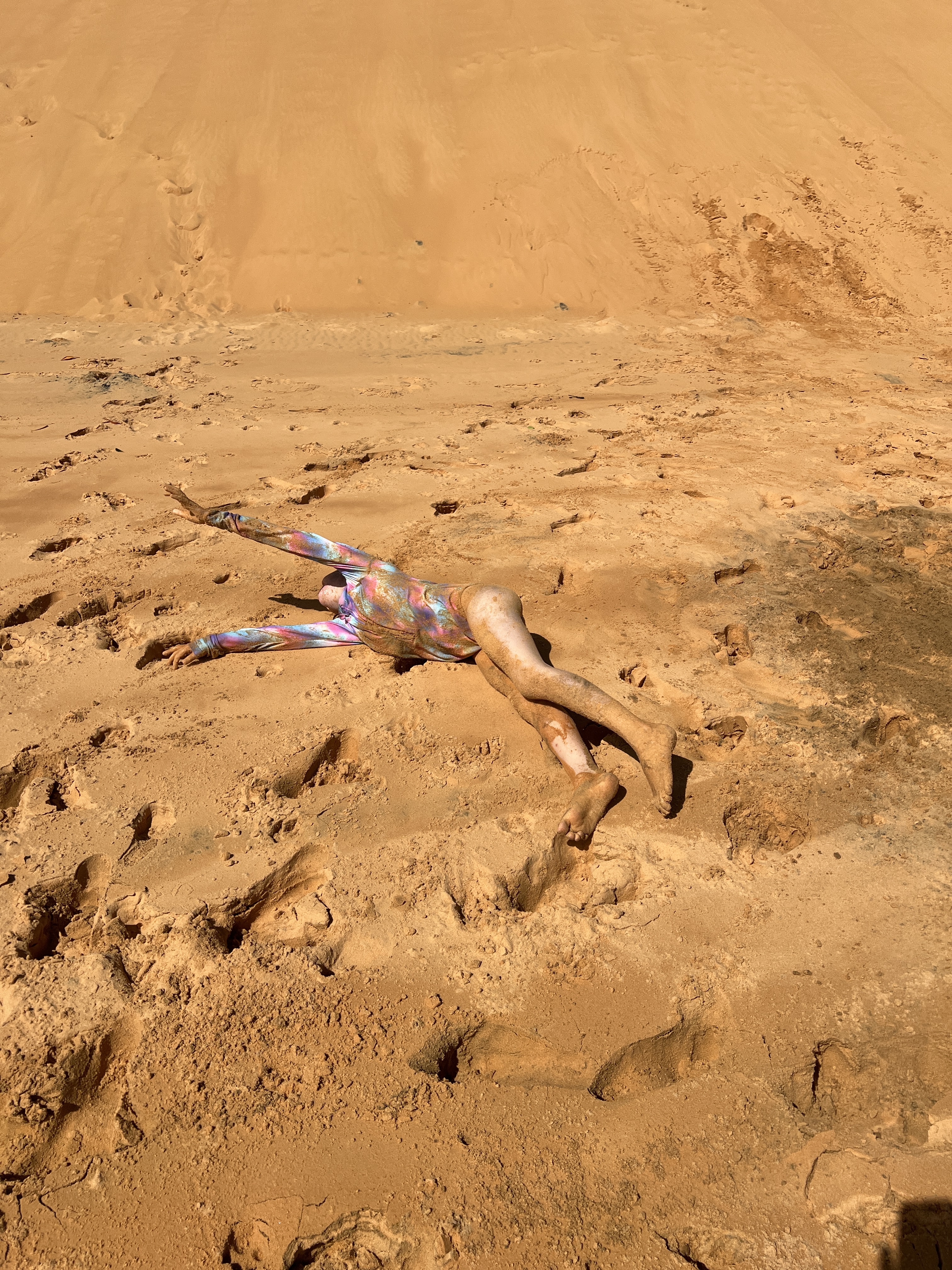 Emma having a good roll in the sand
